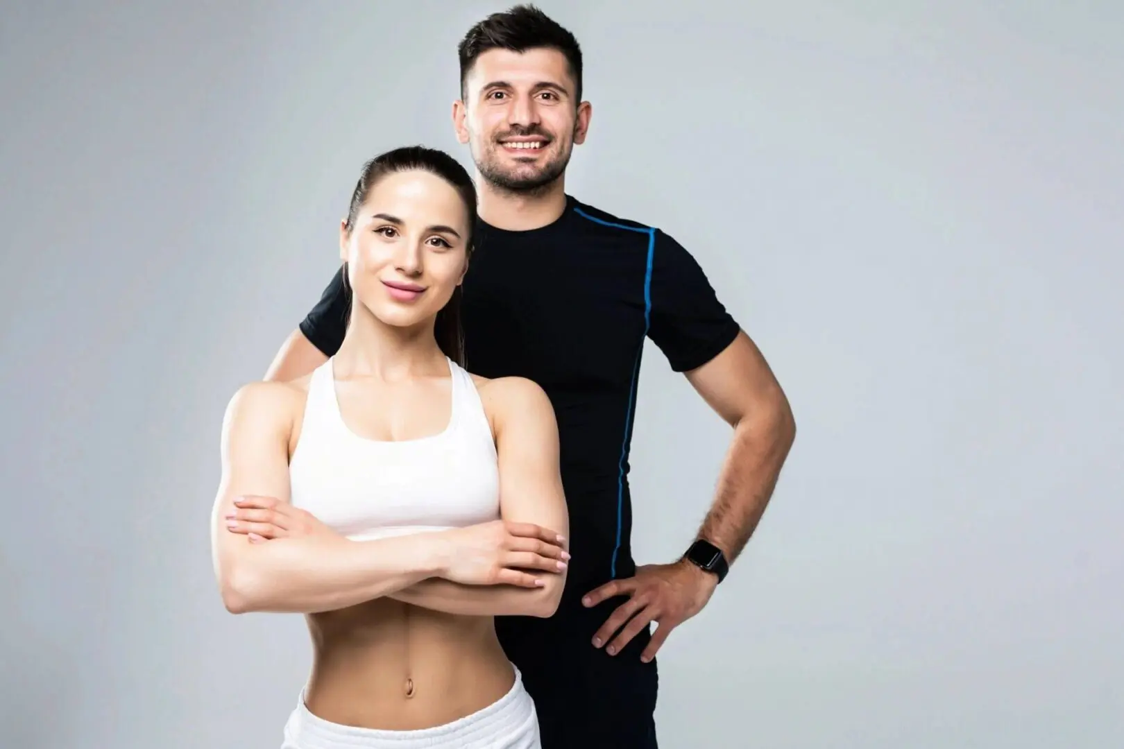 Team of fitness coaches man and woman isolated on gray background