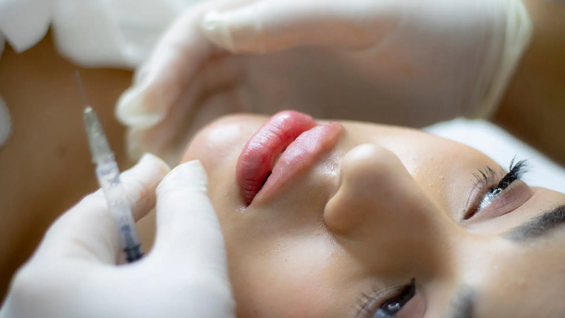 A woman getting her lips waxed at the spa