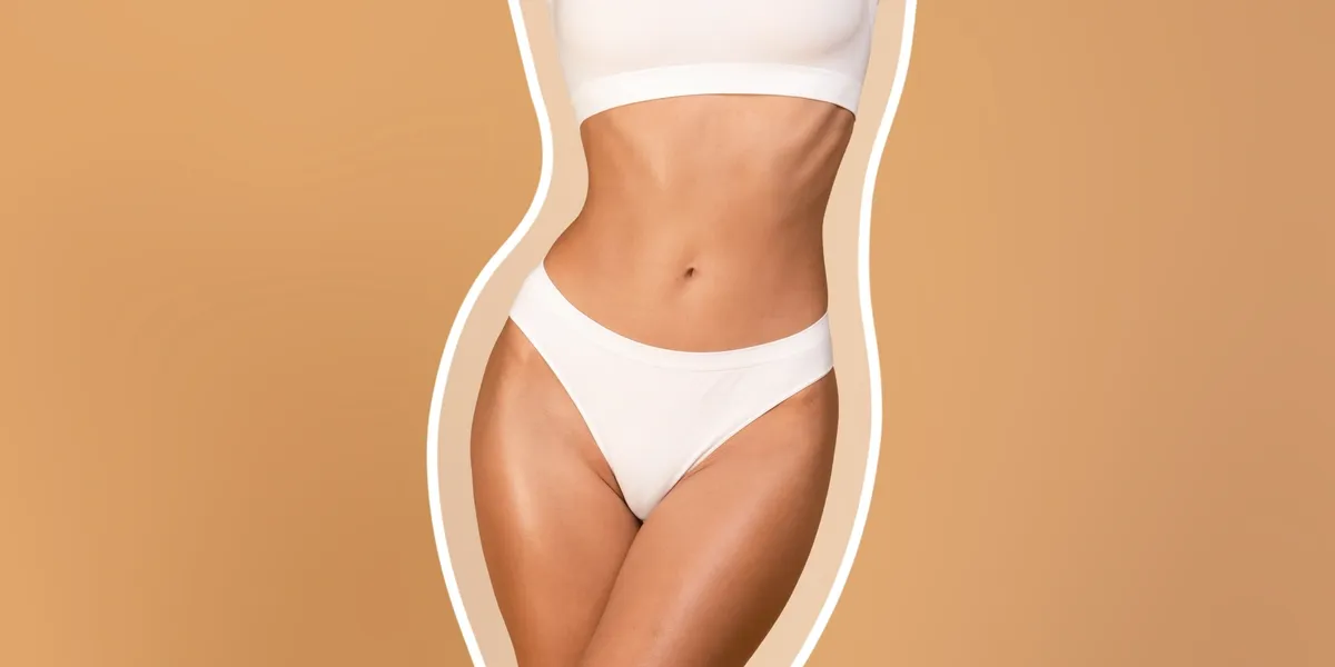 A woman in white underwear standing next to an orange wall.