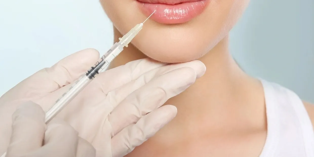 A woman getting her lips filled with botox.