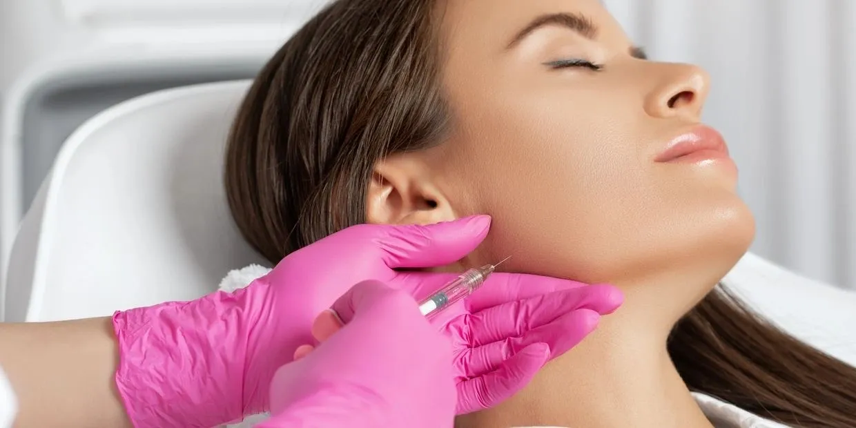 A woman getting her face waxed at the salon