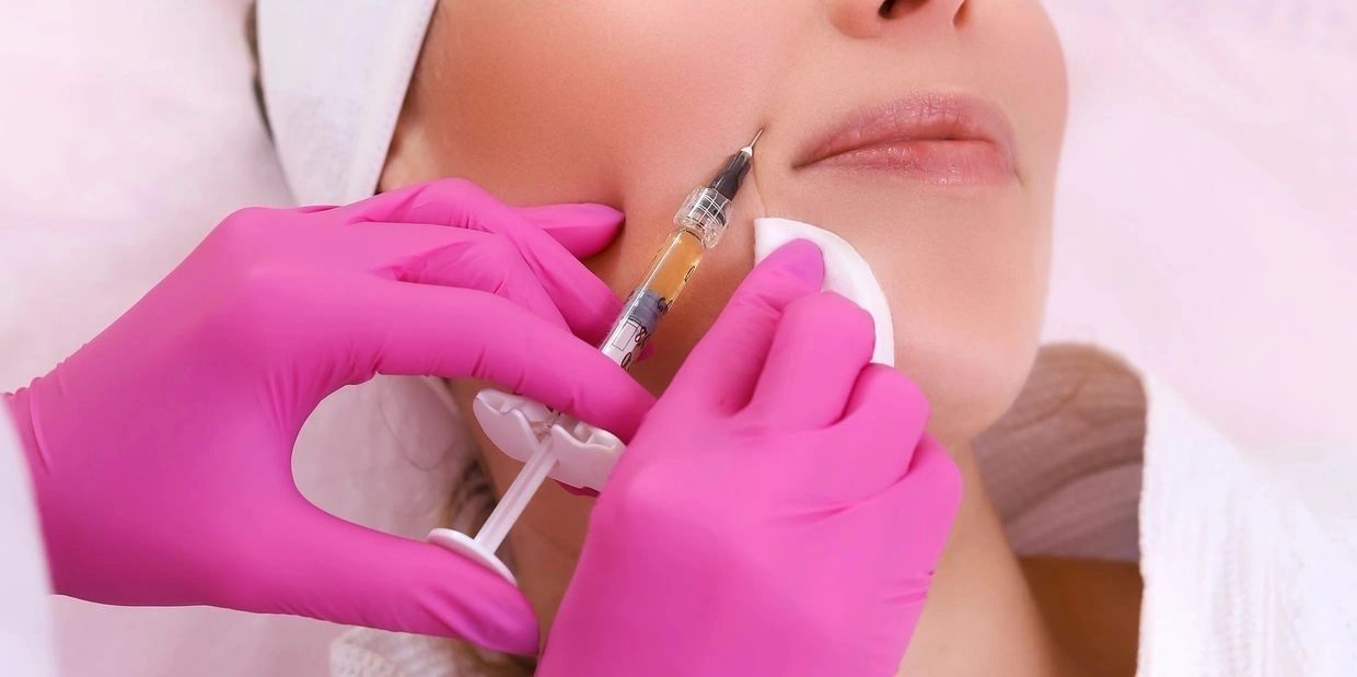 A woman getting her face waxed at the salon