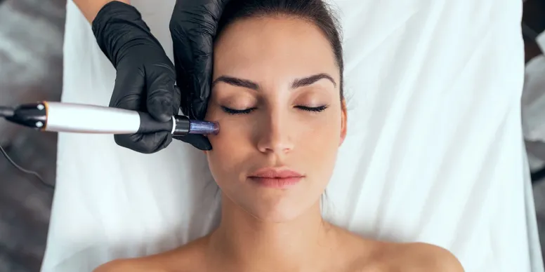Cosmetologist making mesotherapy injection with dermapen on face for rejuvenation